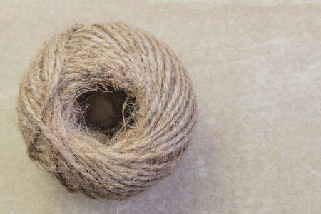 Twine rope jute linen in bobbins skeins close-up on a vintage background with copy space, household goods, production of rope products.の写真素材