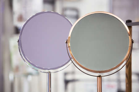 Two cosmetic mirrors without close-up reflection, personal care accessories.の写真素材