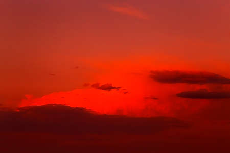 Red orange epic dramatic scary mystical sunset sky with clouds, bright colorful sky landscape background.の写真素材
