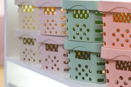 Organization of home space and comfort, boxes containers baskets for wardrobe closets, household goods for storing things. Industrial background with plastic productsの写真素材