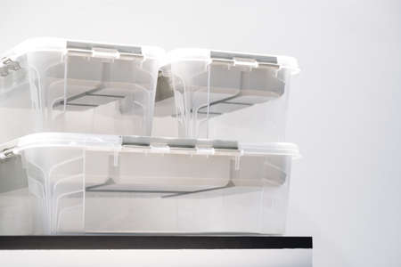 Plastic containers on a shelf on a rack for organizing home space, order and interior, sale of...