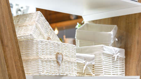 Organization of home space, order, cleanliness and comfort. Household goods storage equipment. Box baskets are woven fabric from trendy natural eco-friendly materials. Interior decor element.の写真素材
