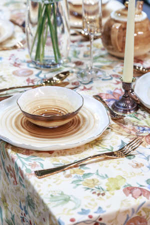 Festive table setting with ceramic plates in eco style. Beautiful original dishes on the table for...