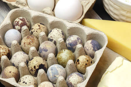Protein food close-up. Quail and chicken eggs, dairy products, cheese and butter, Source of calcium,...