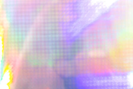 Rainbow holographic futuristic abstract foil texture background with copy space.
