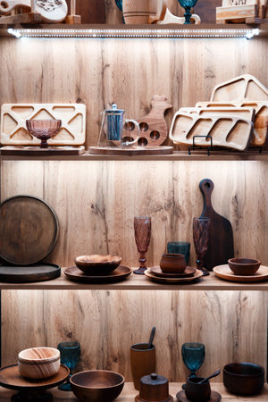 Wooden utensils. Kitchen utensils made of beech and bamboo on a shelf. Eco friendly concept, home...