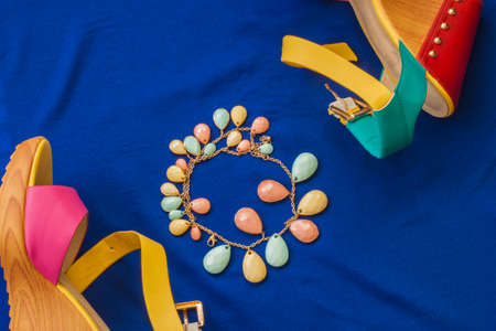 Summer sandals and bracelet on a blue backgroundの写真素材