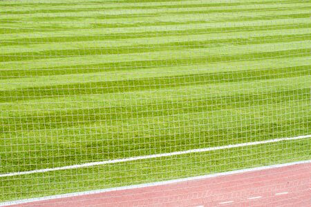 Close up of white soccer net on green background and Beautiful pattern of  green grass for football...