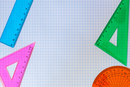 Geometry Set of rulers, triangles, and compass for school on a white background of exercise book. With your place for the textの写真素材