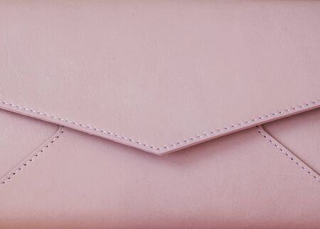 Close-up pink clutch in form of an envelope with space for your logo or textの写真素材