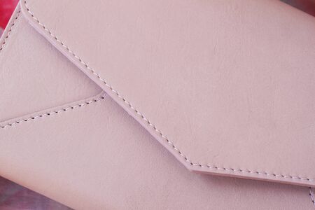 Close-up pink clutch in form of an envelope with space for your logo or textの写真素材