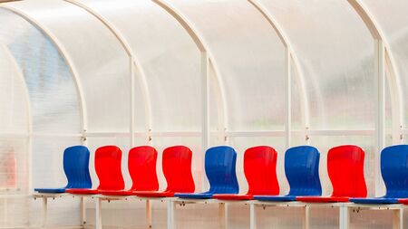 Empty bright seats in stadium for football teams, Seat replacement football team playersの写真素材