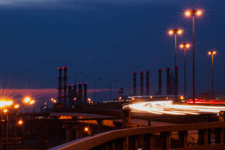 Light of city with blur focus. Night landscape with roads , buildings and tubes on the background. View from the top.の写真素材