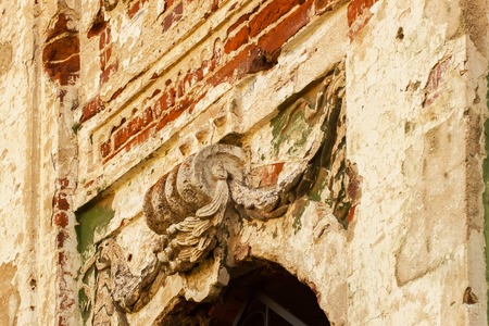 Architectural detail, bas-relief on facade of old medieval manor with arched windowsの写真素材