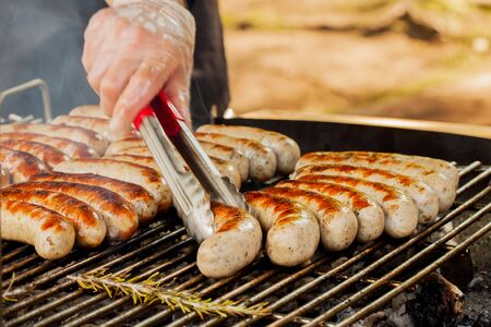 Summer BBQ. Grill spicy browned sausage on the barbecue-party