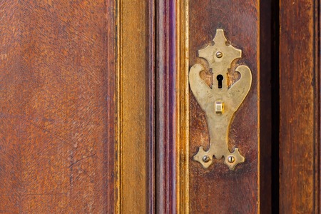 Part retro wooden cabinet with brass fittings, texture and backgroundの写真素材