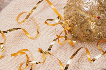 Christmas-tree decoration glass ball on a light knitted scarf - xmas and New Year's concept. With place for your textの写真素材