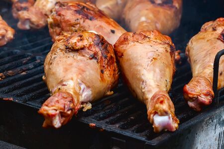Closeup turkey legs on barbecue grill with smoke. Selective focusの写真素材