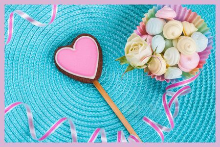 Pink gingerbread cookie in the shape of a heart on the turquoise background. Selective soft focus, pastel processing. Symbol  love, Valentines Dayの写真素材