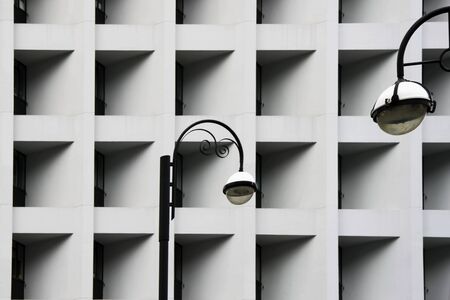 Street lamps against Modern abstract urban building. Detailed geometric black and white pattern in...