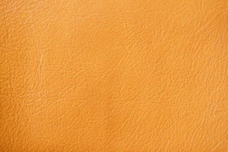 Texture of genuine leather close-up, red-based orange, for background , backdrop, substrate, composition use.の写真素材