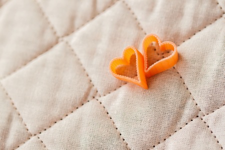 Romantic abstract picture, pasta in the form a heart, two pieces. Food background for Valentines...