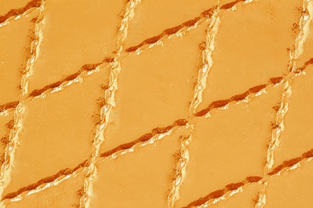 Genuine leather with rhombus stitched. Closeup on a leather texture surface with a rhombus stitch. For modern pattern, wallpaper or banner design. With place for your textの写真素材