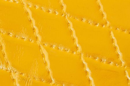 Genuine leather with rhombus stitched. Closeup on a leather texture surface with a rhombus stitch. For modern pattern, wallpaper or banner design. With place for your textの写真素材