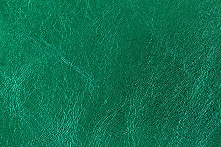 Texture of genuine leather close-up, fashion emerald color. For modern pattern, wallpaper or banner design. With place for your textの写真素材