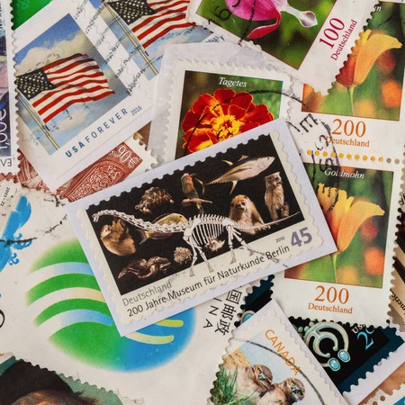 Pile of old random used postage printed stamps from various countries and different time, square. For pattern, wallpaper, banner design, backgroundの写真素材