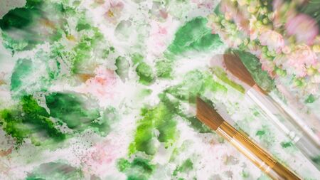 Abstract art hand watercolor and brushes, floral background. Blurred romantic concept of spring, lifestyle, hobbies. Top view. With place for your text, for backdrop, substrate, composition use.の写真素材