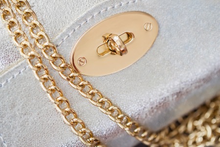 Close-up texture of evening silver small handbag from genuine leather with beautiful gold details. Concept of shopping, manufacturing, lifestyle, holiday, weekendの写真素材