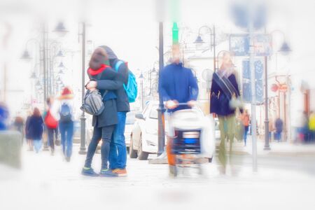 Abstract background. Intentional motion blur. Early spring, kissing couple on the street. Families...