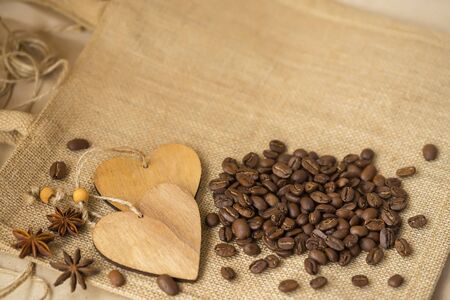 Grains of roasted coffee on sackcloth background with copy space. Frame for creative concepts of hot drinks for any day or advertisingの写真素材