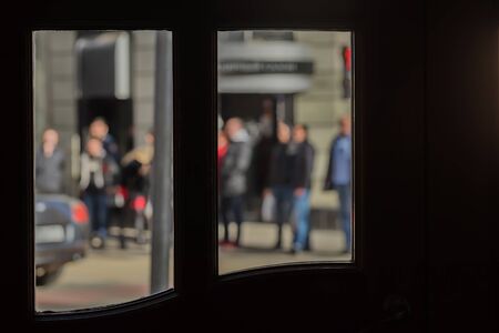 View from a cafe window on a small street of the old city, pedestrians. Intentional motion blurの写真素材