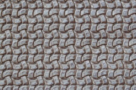 Texture of genuine Braided leather close-up. Fashion trend leather background in grey color, copy...