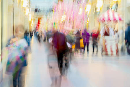 Abstract defocused motion blurred People in bright clothes walking in the shopping center, urban lifestyle concept. For background , backdrop, substrate. Spring salesの写真素材