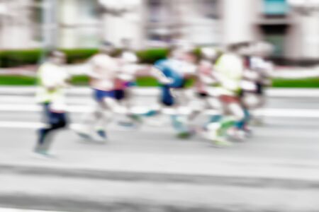 Group of young runners athlete running on the street, city marathon, blur effect, unrecognizable face. Sport, healthy lifestyle concept. For backdrop, place for textの写真素材
