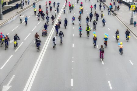 Large group of bicyclists on street, city marathon, Back to us, unrecognizable. Sport, healthy...
