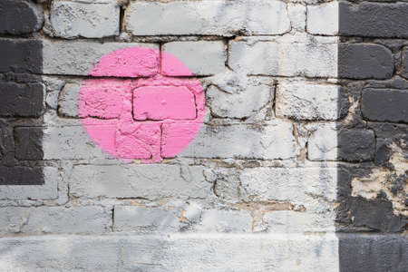 Colorful brick wall with fragment of graffiti, abstract drawings art close-up. Modern iconic urban culture. Modern pattern, wallpaper, banner design, backdropの写真素材