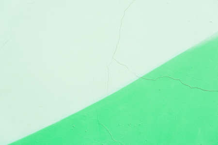 Abstract grunge texture background, different shades of green color. Detail of cracked old plaster wall, fragment graffiti, old chipped paint, scratch. For backdropの写真素材