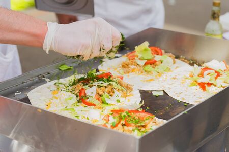 Close-up of hands of cook. Easy to prepare, but tasty, healthy and hearty. Concept of Mexican food. Party food, fresh Oganic food, recipes and cooking.の写真素材
