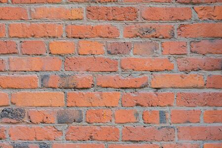 Vintage red painted old brick with cracks and scratches for natural design, patterns