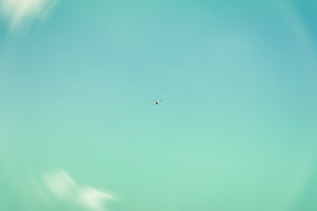 Texture of sky, beautiful turquoise or azure color, white fluffy clouds. High in the sky flies...