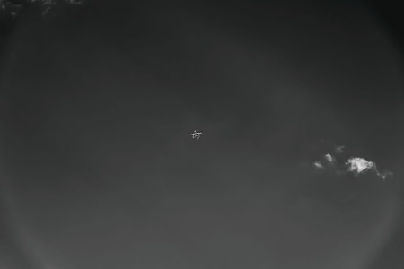 Stylized background with copter, drone, quadrocopter flying high in sky, reminding UFO, unidentified spaceship of aliens. Concept of contact with extraterrestrial civilization, futuristic alien transportの写真素材