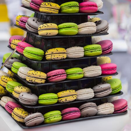 Pyramid of different french colorful macaroons various flavors and diffrent colors, french sweet cookies from almond flour, on market counterの写真素材