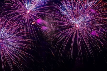 Close-up of vivid purple fireworks with sparks. Explosive pyrotechnic devices for aesthetic and entertainment purposes, art. Colored fireworks, holiday backgroundの写真素材