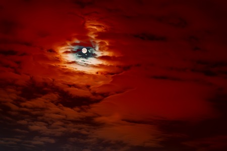 Abstract Natural scary Halloween background, full moon, dark red cloudy sky, bright super moon.の写真素材