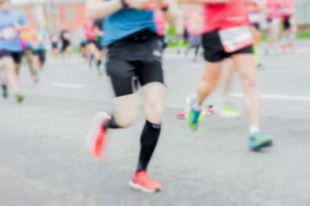 Close-up of feets, legs of runners, marathon on city streets. Abstract blurred sport background. Sport, fitness, healthy lifestyleの写真素材