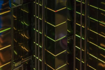 Close-up abstract of pattern of bright vivid led backlight walls of high glowing building, modern lighting of buildings. Modern futuristic background. Small motion effectの写真素材
